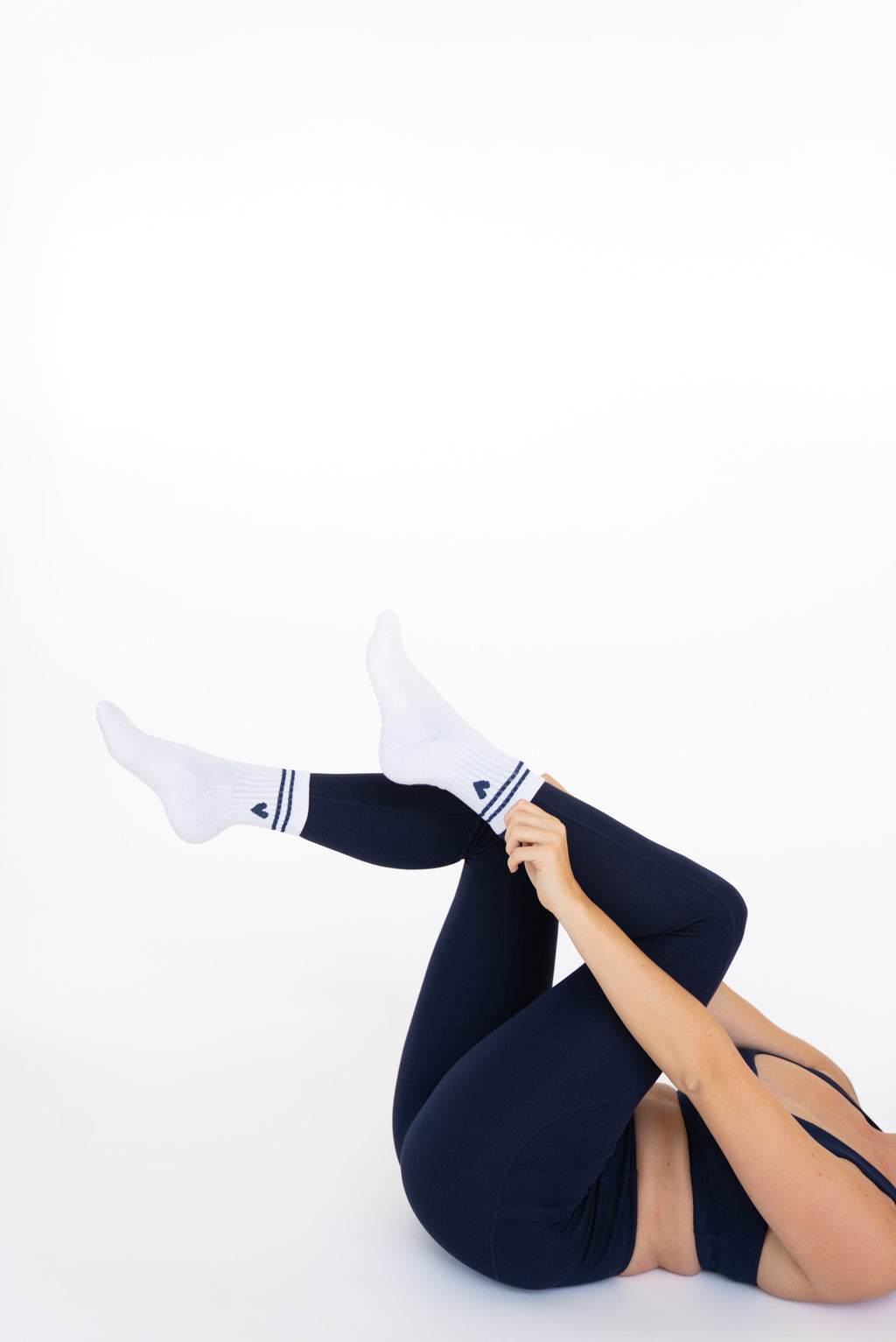 Lavoréa Pilates Cushioned Grip Socks in Navy Blue, side view with legs extended