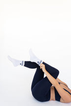 Lavoréa Pilates Cushioned Grip Socks in Navy Blue, side view with legs extended