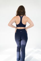 Lavoréa Wrap Waist Flare Leggings worn with the Everyday Sports Bra, both in Navy Blue organic cotton