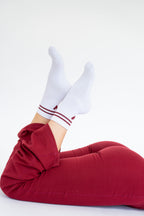 Lavoréa Pilates Grip Socks in Burgundy, both soles angled toward the camera