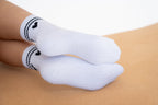 Lavoréa Pilates Cushioned Grip Socks in Black, silicone grip on the sole seen in profile on a cork mat